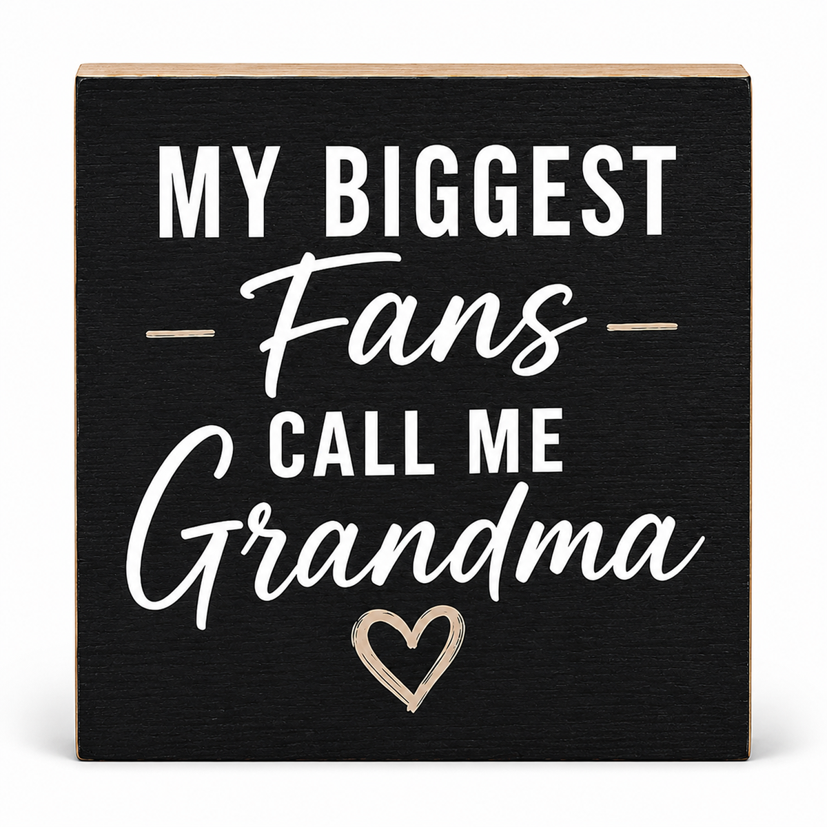 A square black decorative sign with a light wood border and white text that reads “MY BIGGEST Fans CALL ME Grandma,” plus a small outlined heart near the bottom, shown on a white background.