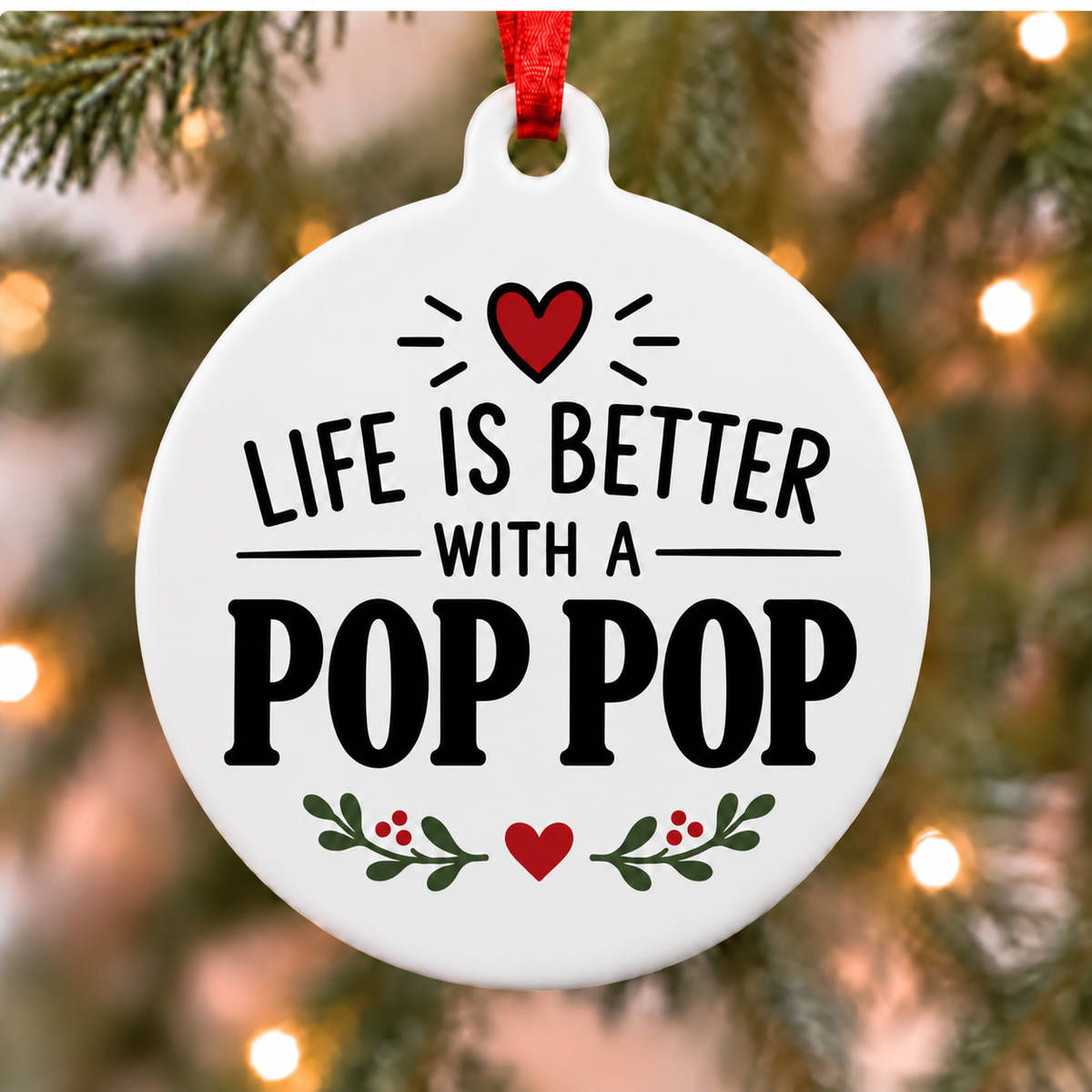 White round Christmas ornament reading Life Is Better With a Pop Pop with a red heart and green leafy accents