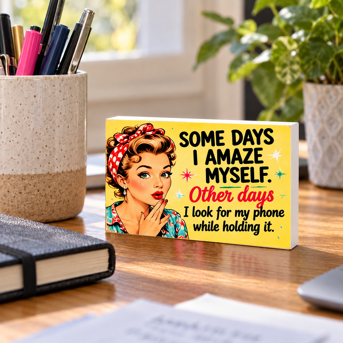 Some Days I Amaze Myself. Other Days I Look for My Phone While Holding It mini sign standing on a desk with white PVC edges.