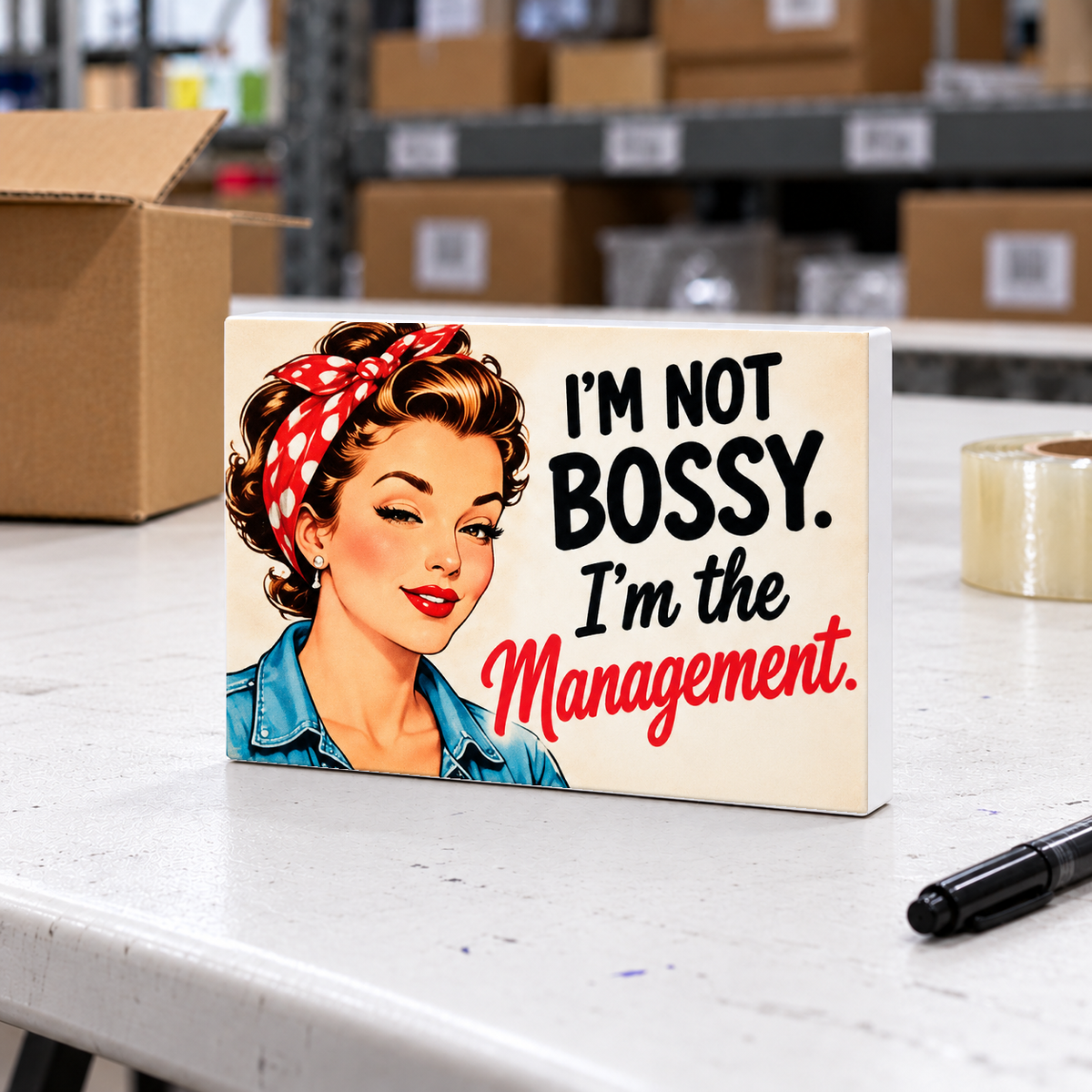 I'm Not Bossy. I'm the Management. magnet and mini sign on a white folding warehouse table.