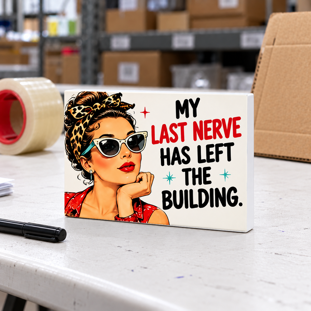 My Last Nerve Has Left the Building magnet and mini sign on a white folding warehouse table.