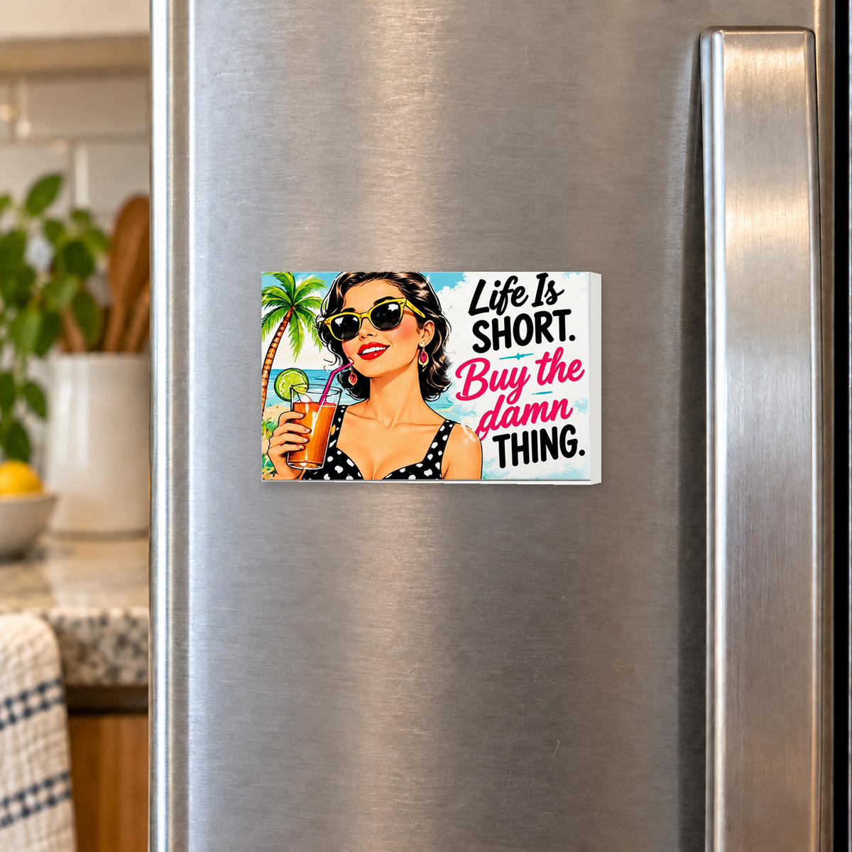 Life Is Short. Buy the Damn Thing rectangular magnet shown front-facing on a refrigerator.