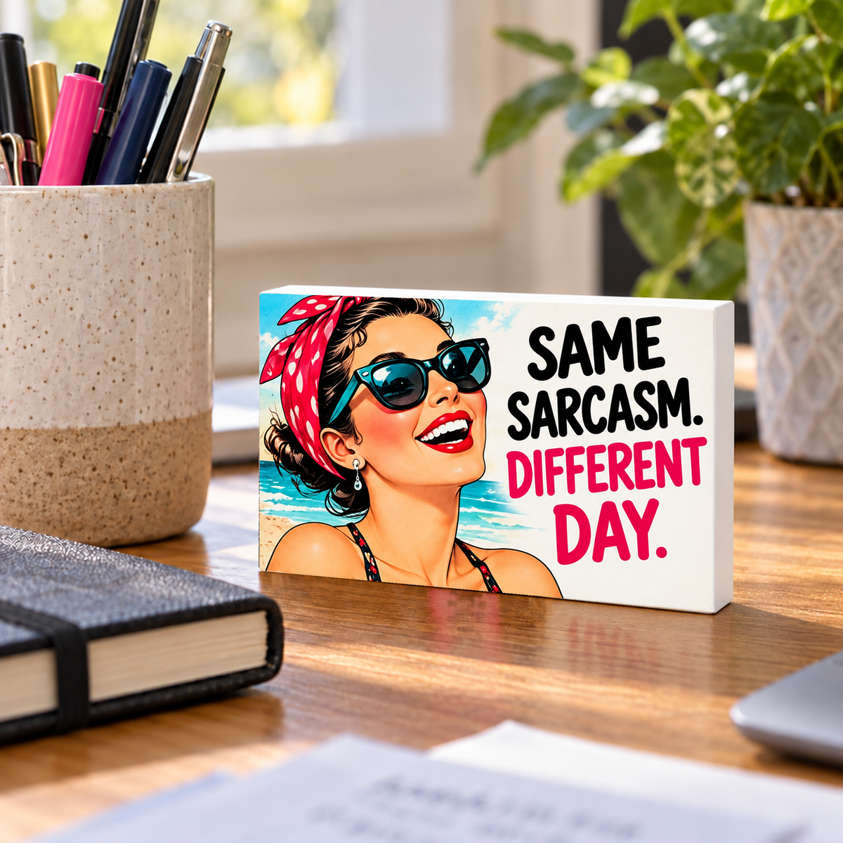 Same Sarcasm. Different Day mini sign standing on a desk with white PVC edges.