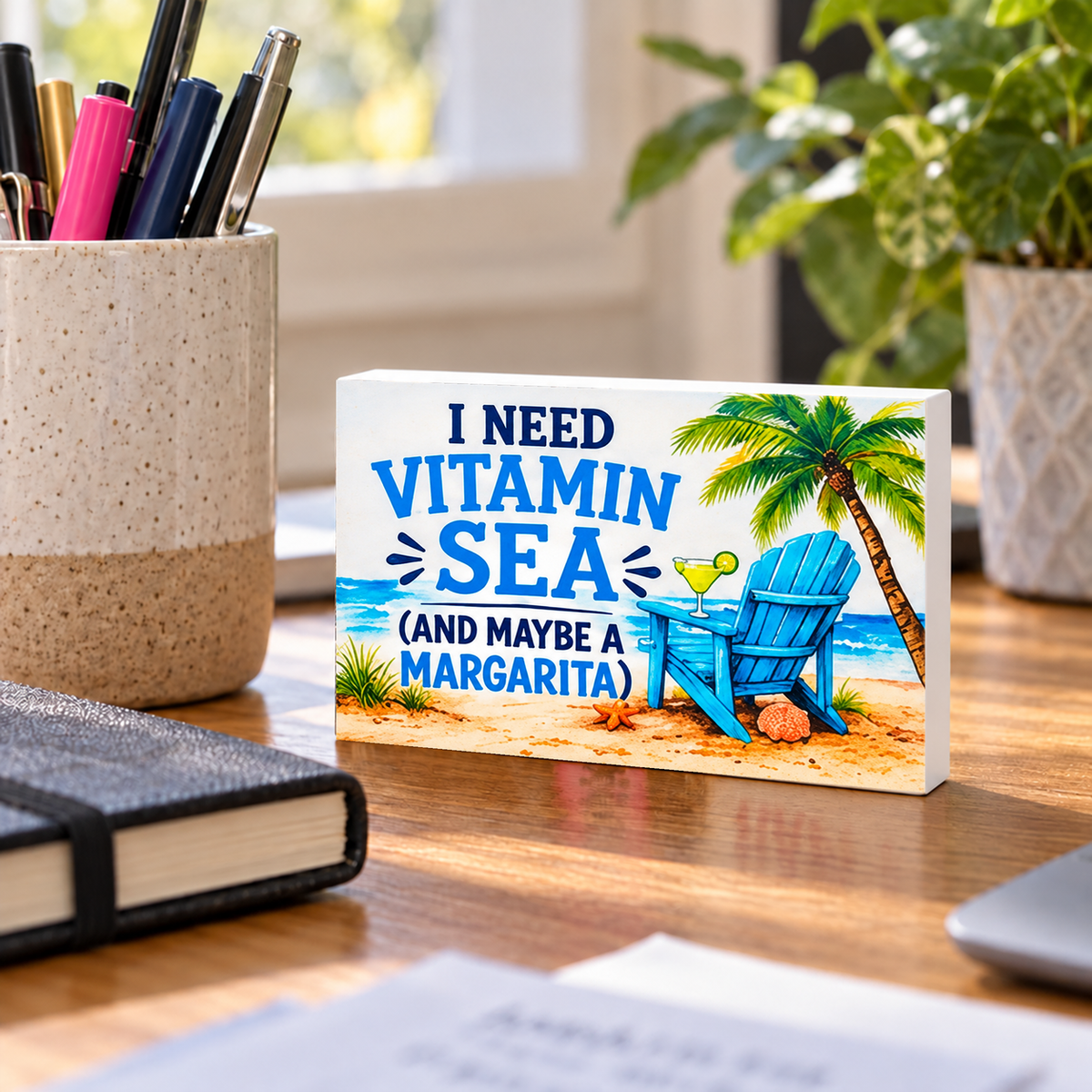 I Need Vitamin Sea (And Maybe a Margarita) mini sign standing on a desk.