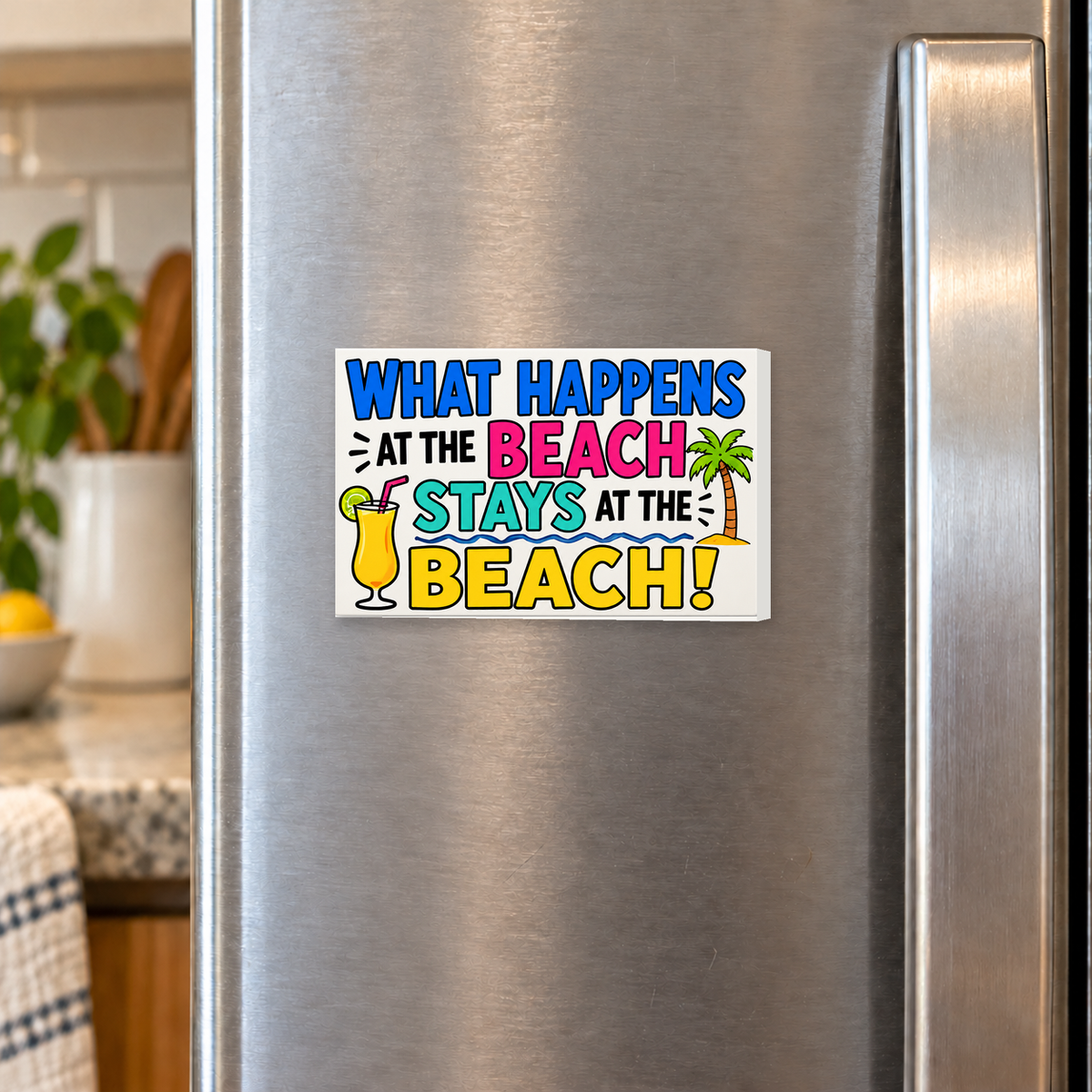 What Happens at the Beach Stays at the Beach rectangular magnet shown front-facing on a refrigerator.
