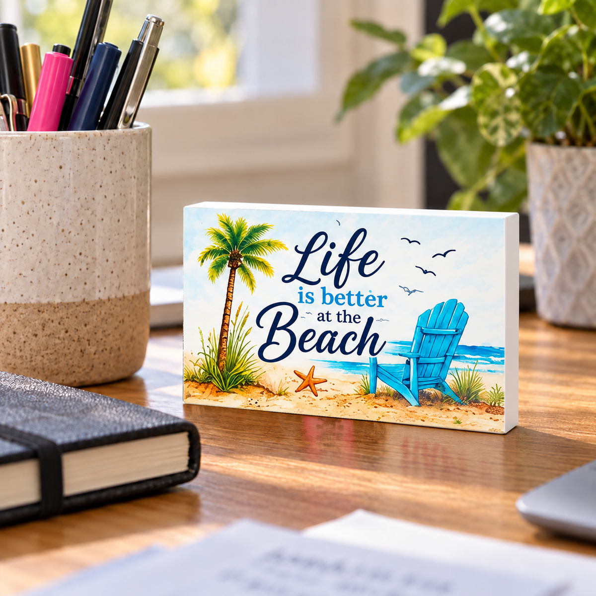 Life Is Better at the Beach mini sign standing on a desk with white PVC edges.