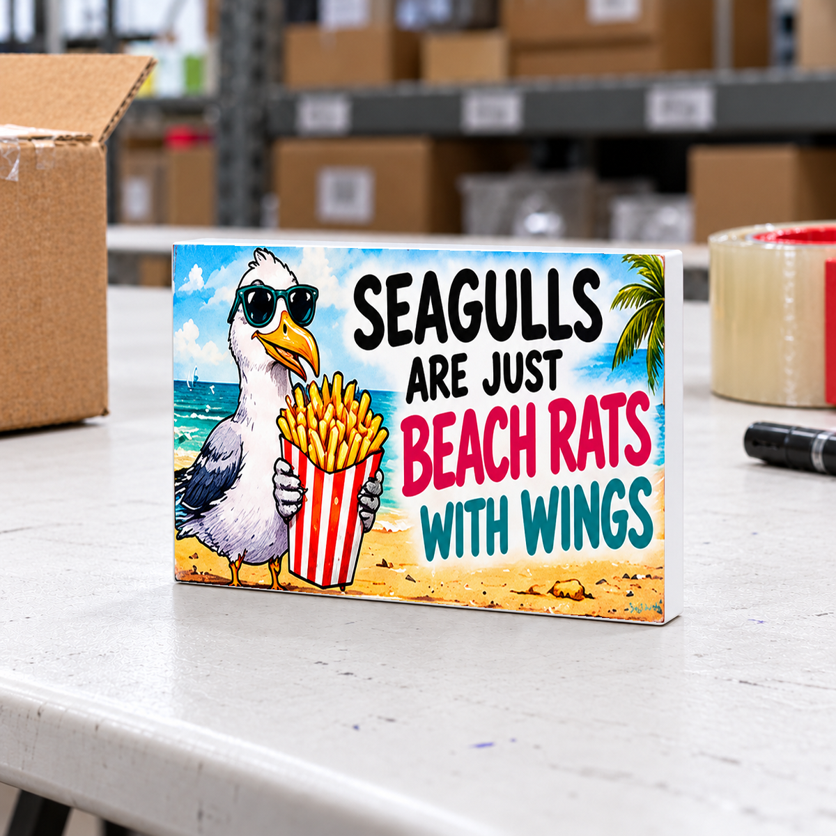 Seagulls Are Just Beach Rats With Wings magnet and mini sign on a white folding warehouse table.