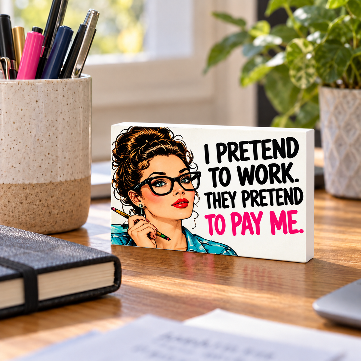I Pretend to Work They Pretend to Pay Me mini sign standing on a desk.