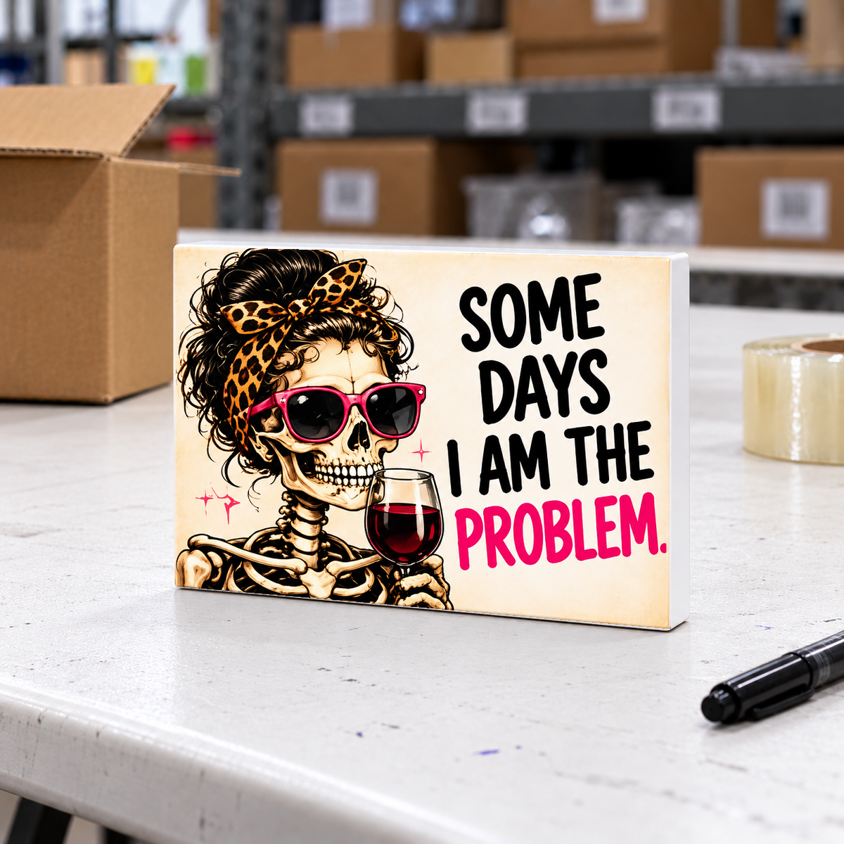 Some Days I Am the Problem magnet and mini sign on a white folding warehouse table.