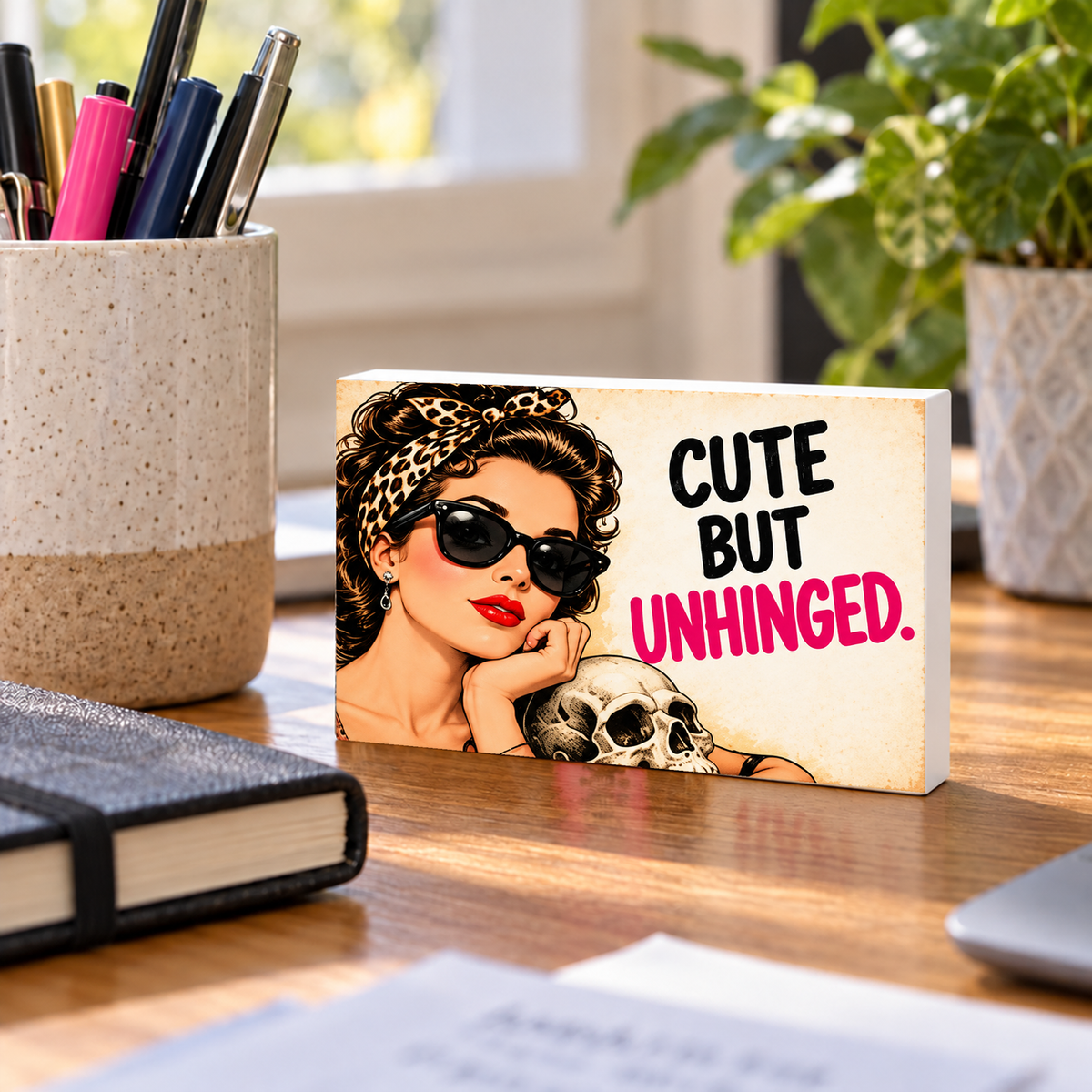 Cute But Unhinged rectangular mini sign standing on a desk with white PVC edges.