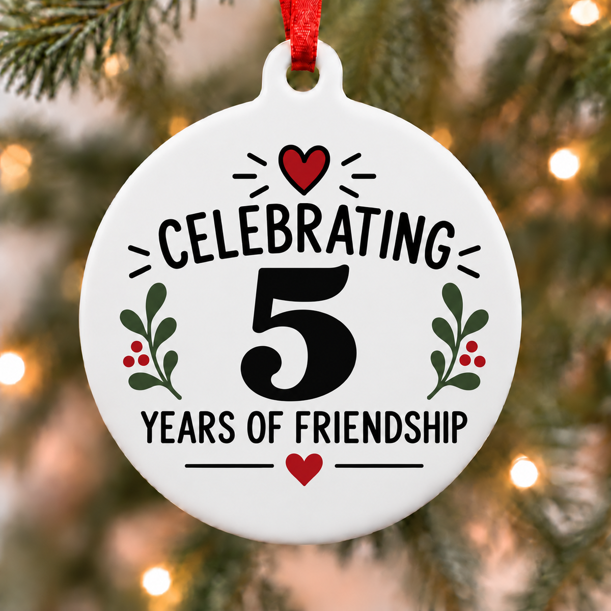 White round Christmas ornament reading Celebrating 5 Years of Friendship with red hearts and green leafy accents