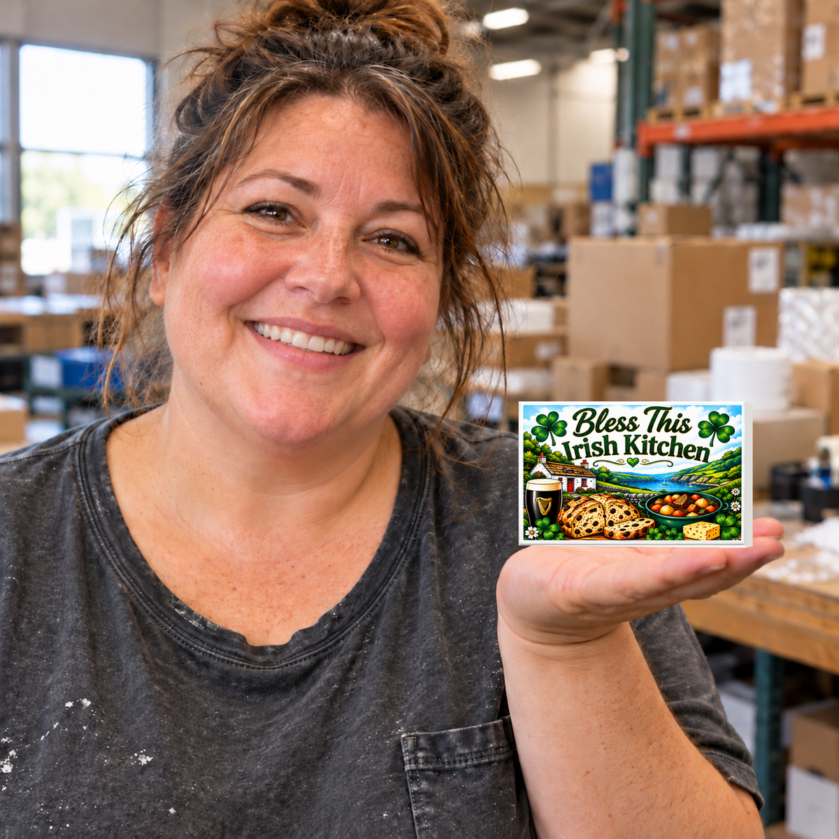 Bless This Irish Kitchen small rectangular magnet held on an open palm in a warehouse setting.