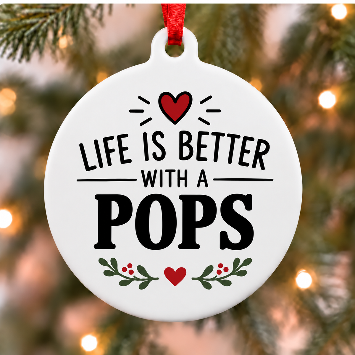 Life Is Better With a Pops PVC Christmas ornament hanging close up on a tree with a red ribbon
