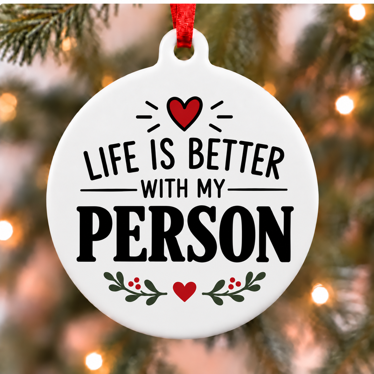 Life Is Better With My Person PVC Christmas ornament close up on an evergreen tree with red ribbon and warm lights