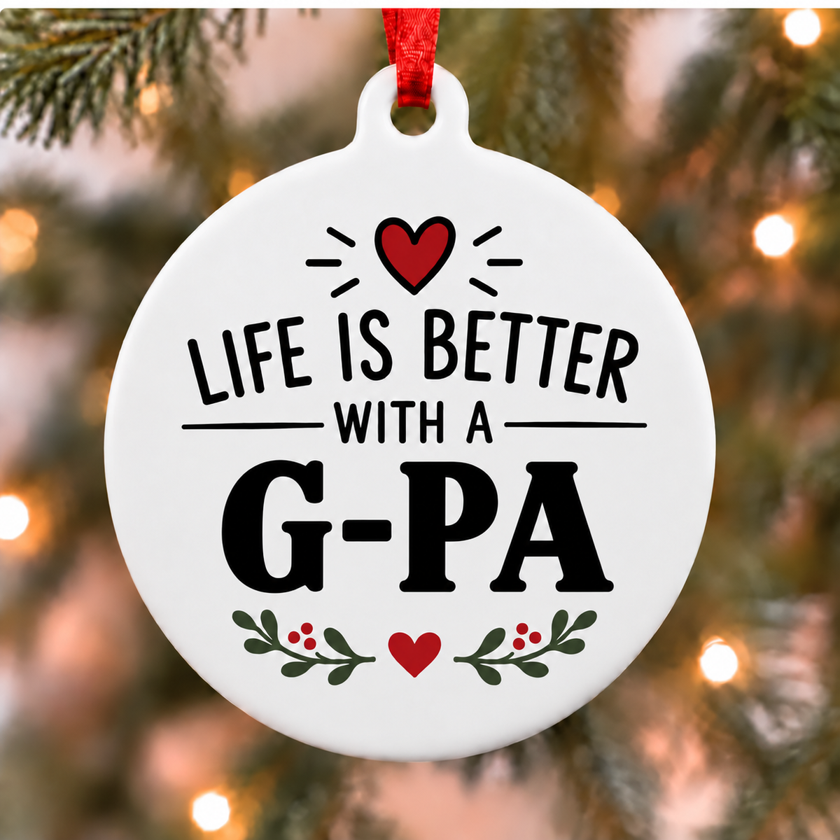 Life Is Better With a G-Pa PVC Christmas ornament close up on an evergreen tree with red ribbon and warm lights