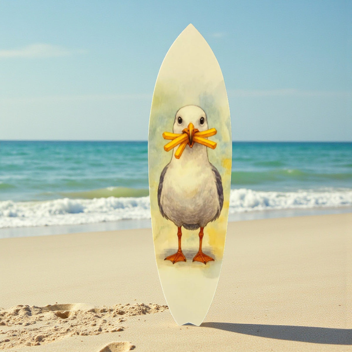 Surfboard with a bird design on a sandy beach with ocean in the background
